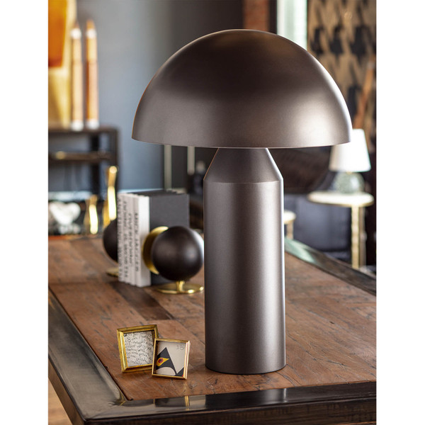 modern black table lamp on a worn wooden console table next to two small picture frames
